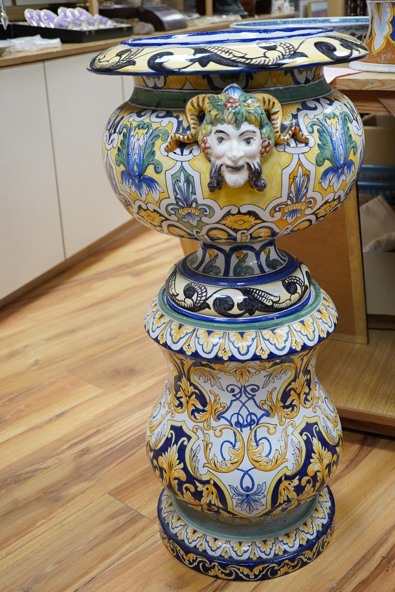 A tall decorative French faience pottery jardiniere with Bacchus mask mounts and a similar associated stand